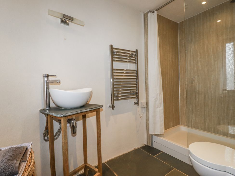 A bathroom with sink and shower at Coombe Barn in Cusgarne near St Day