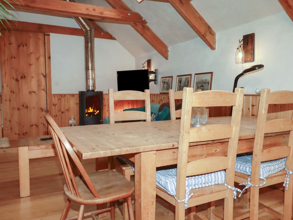 A dining room with a table and chairs at Stribleys Barn in Cusgarne near St Day