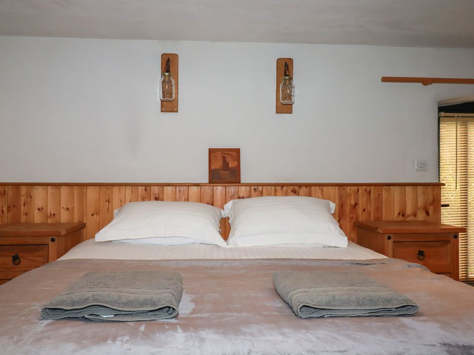 A bedroom with a bed and bedside tables at Stribleys Barn Cusgarne near St Day