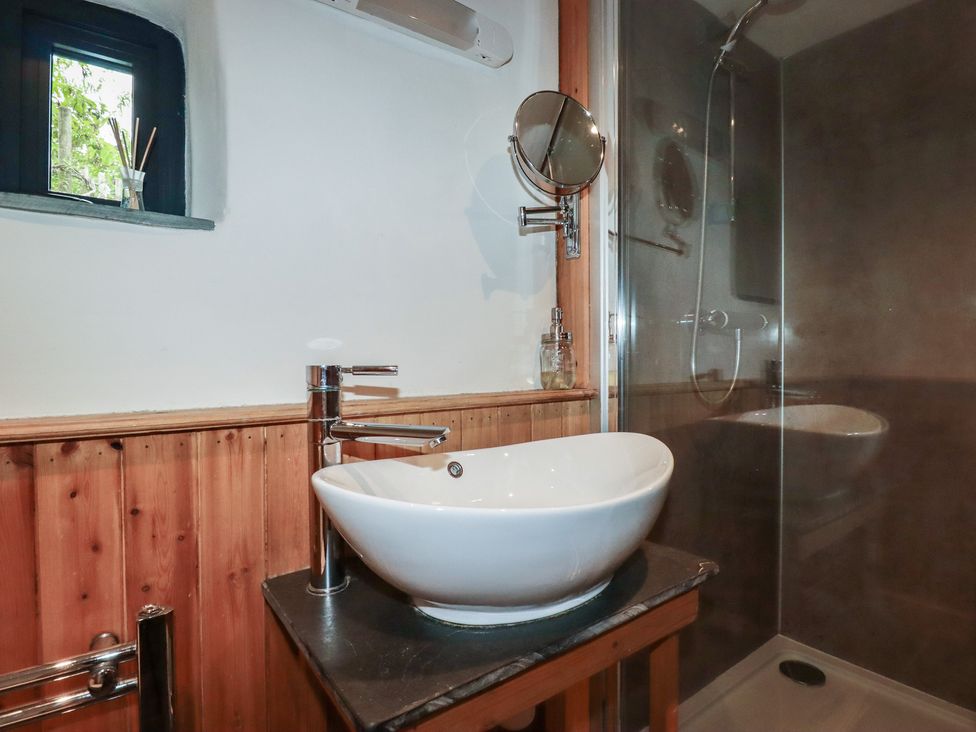 A bathroom with a sink and shower at Stribleys Barn Cusgarne near St Day