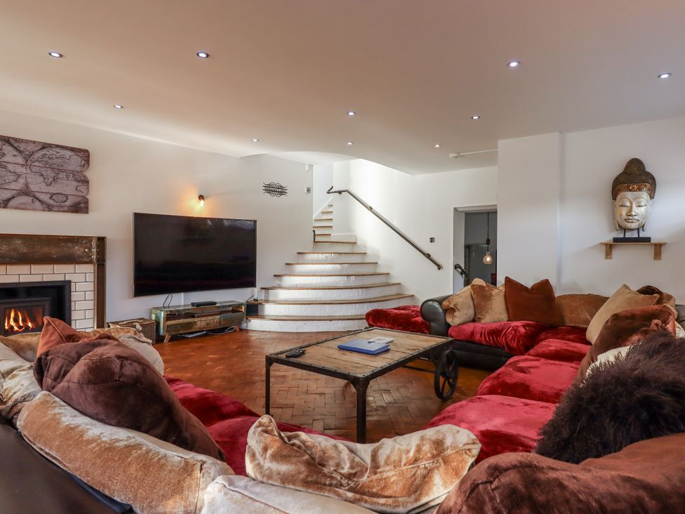 A living room with a sofa and television at Delmonte Lodge in Torquay
