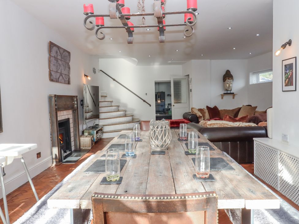 A dining room with a table and chairs at Delmonte Lodge in Torquay