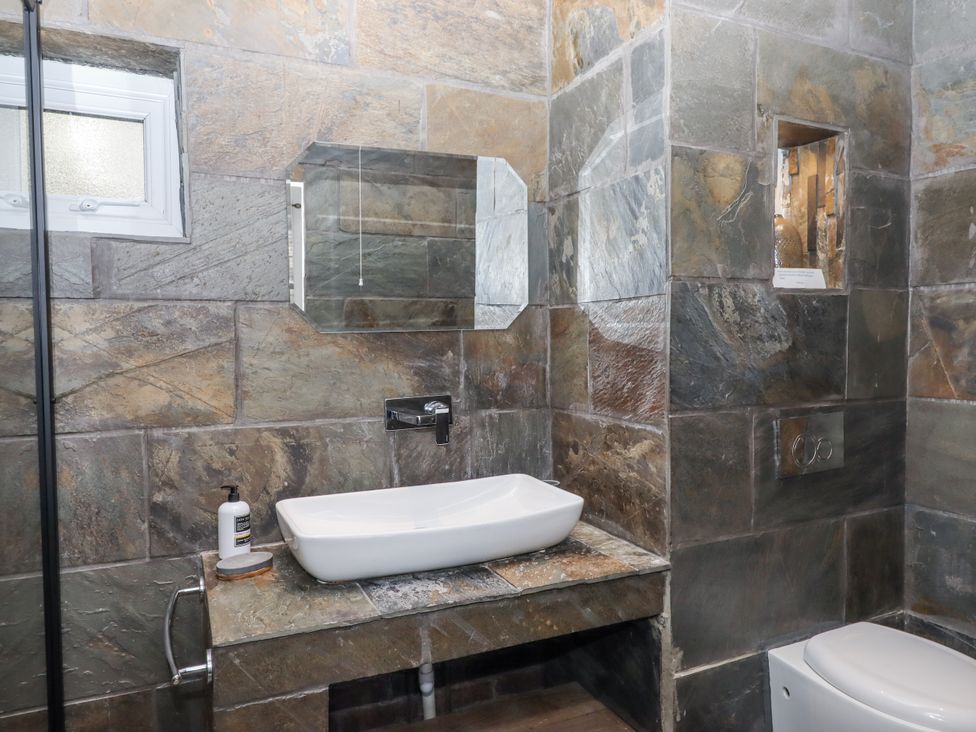 A bathroom with a sink and toilet at Delmonte Lodge in Torquay