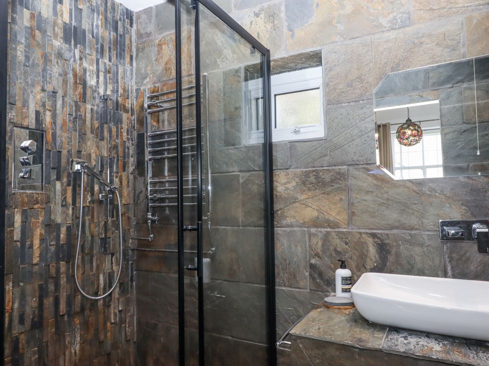 A bathroom with a shower and sink at Delmonte Lodge in Torquay