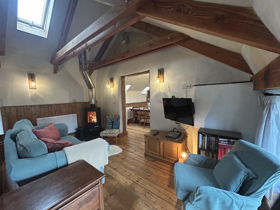 A living room with a sofa and television at Pit Paddy Barn in Cusgarne near St Day