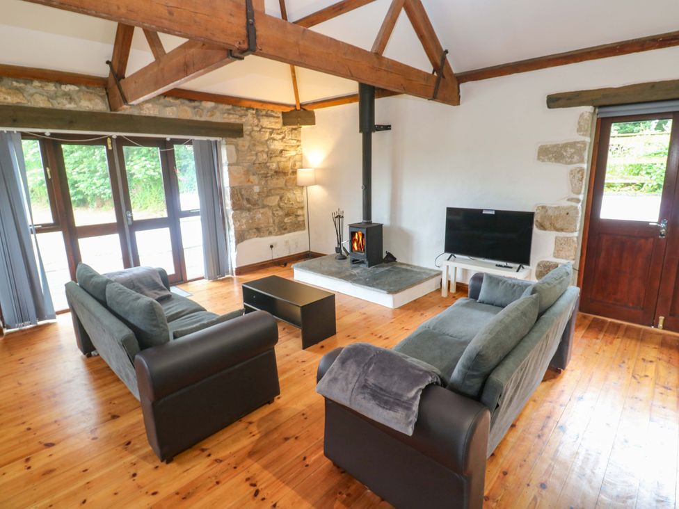 A living room with sofas and a television at The Shippen in Rosudgeon