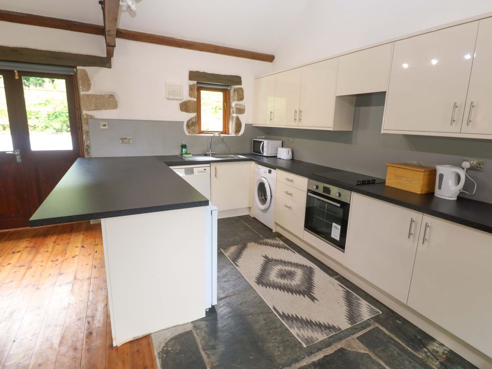 A kitchen with appliances and a countertop at The Shippen in Rosudgeon
