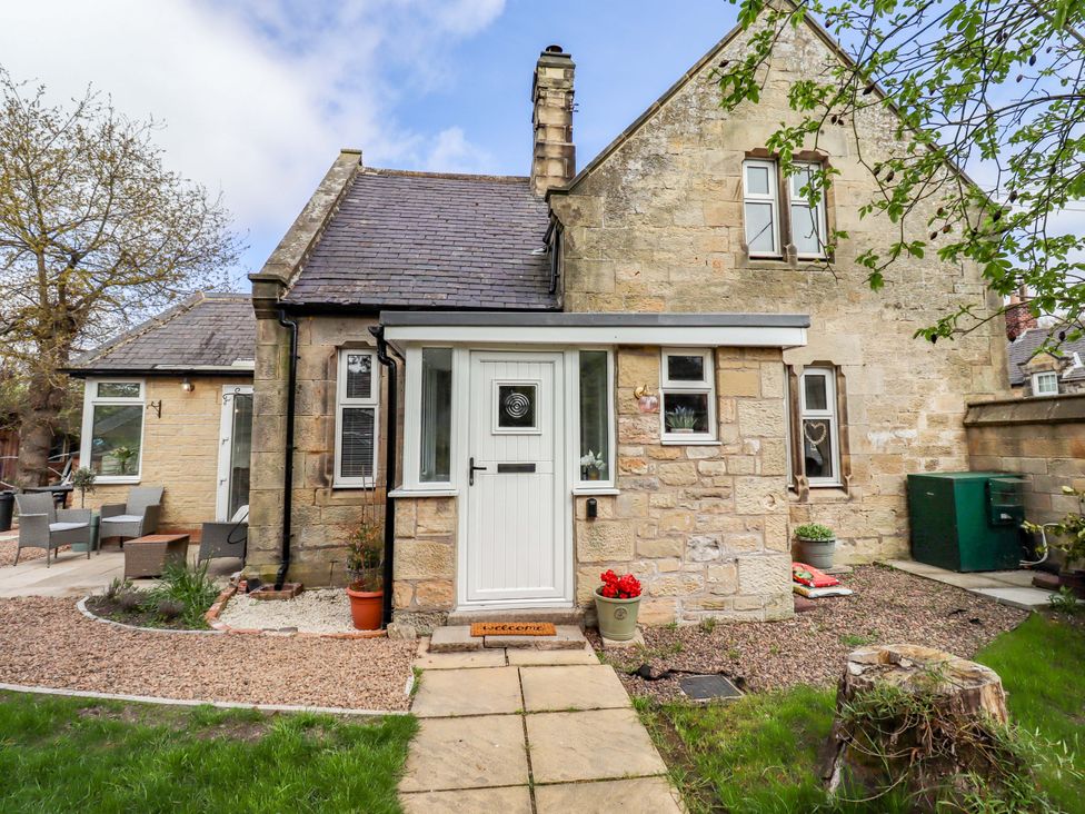 An exterior view of a house showing a door and pathway at The Lodge in Powburn