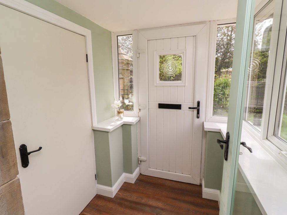 A hallway with a door and windows at The Lodge in Powburn