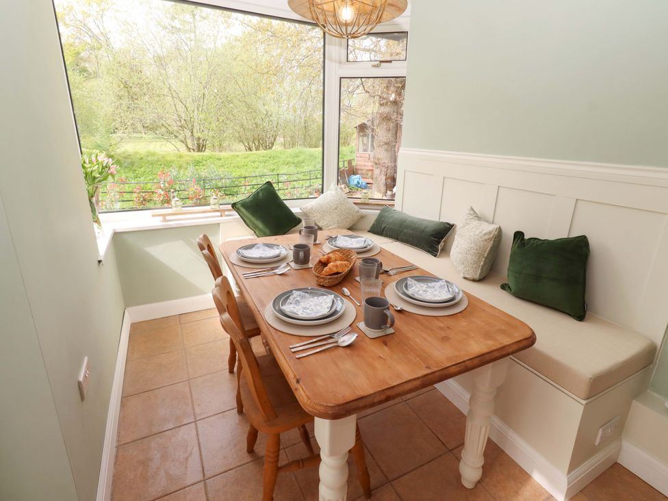 A dining room with a table set for meals at The Lodge in Powburn
