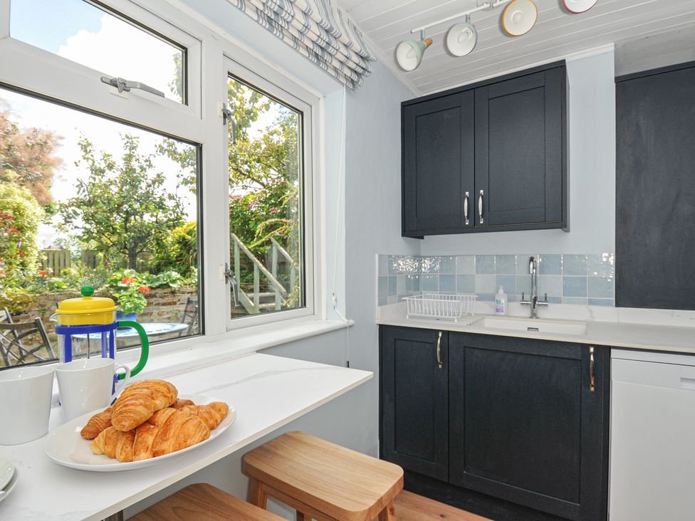 A kitchen with a countertop and croissants at 2 Porthilly Cottages in Rock