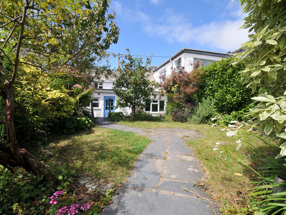 A garden with a pathway and plants at 2 Porthilly Cottages in Rock
