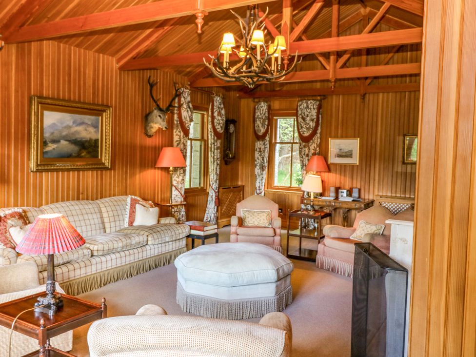 A living room with a sofa and armchairs at Creag Bhalg near Mar Lodge Braemar