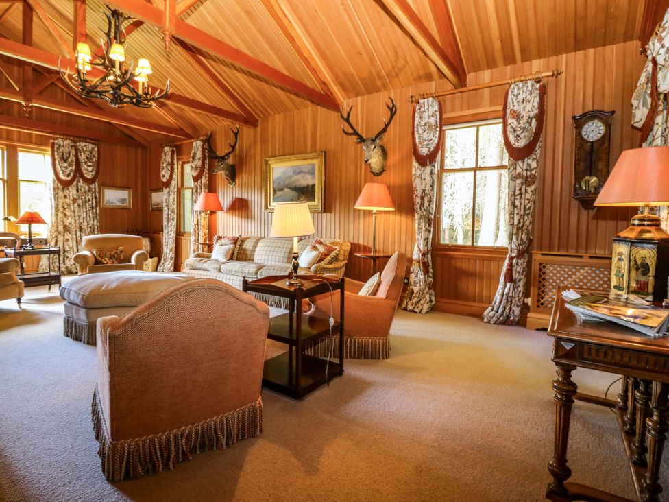 A living room with a sofa and armchairs at Creag Bhalg near Mar Lodge Braemar