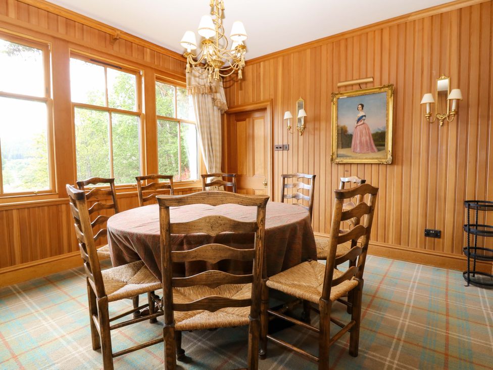 A dining room with a wooden table and chairs at Creag Bhalg near Mar Lodge Braemar