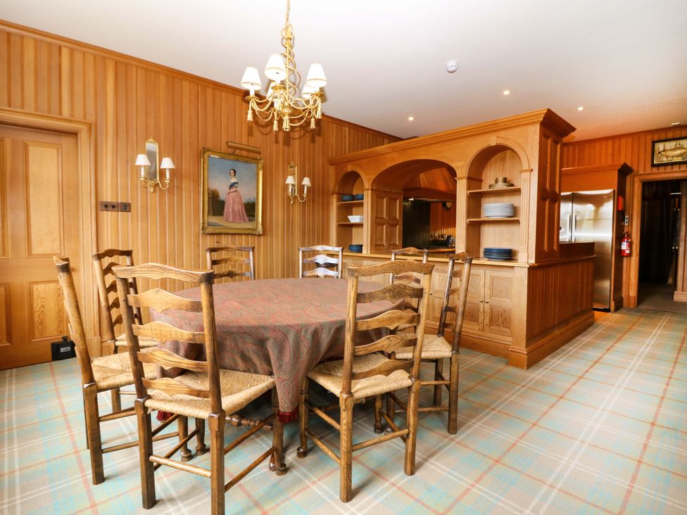 A dining room with a table and chairs at Creag Bhalg near Braemar