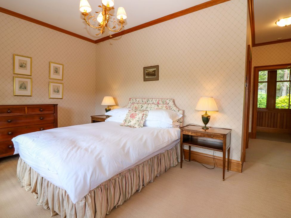 A bedroom with a bed and nightstand at Creag Bhalg near Mar Lodge