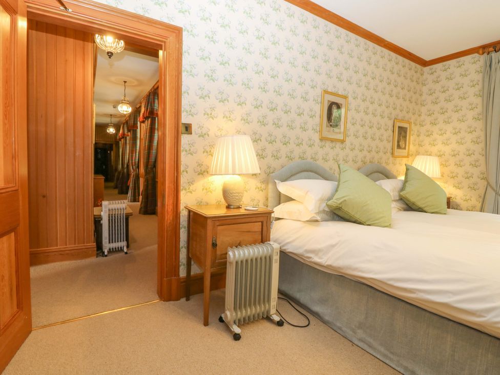 A bedroom with a bed and nightstand at Creag Bhalg near Mar Lodge near Braemar