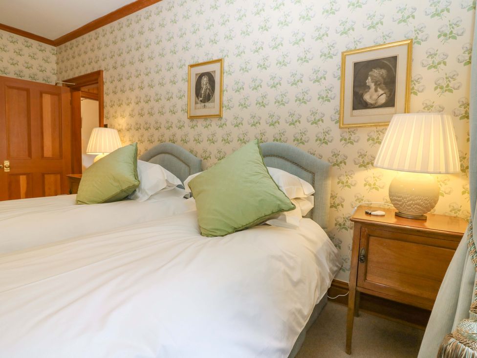 A bedroom with two beds and a nightstand at Creag Bhalg near Mar Lodge near Braemar