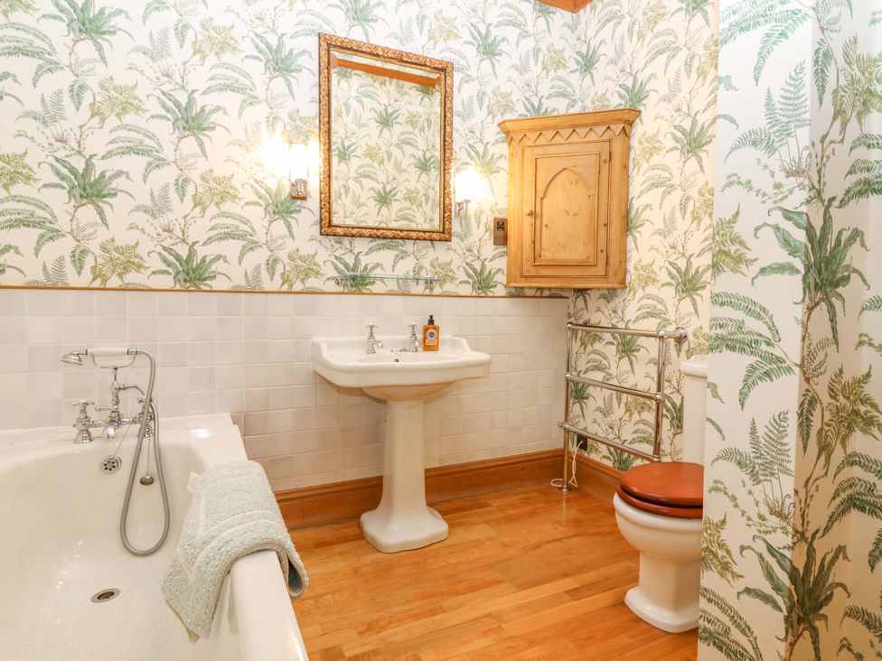 A bathroom with a sink, bathtub and toilet at Creag Bhalg near Mar Lodge in Braemar