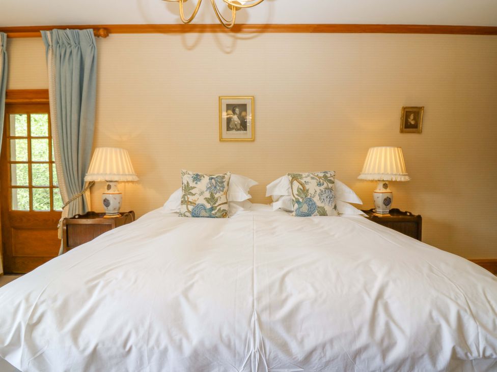 A bedroom with a double bed and lamps at Creag Bhalg near Braemar