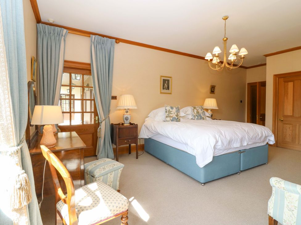 A bedroom with a bed and furniture at Creag Bhalg near Braemar