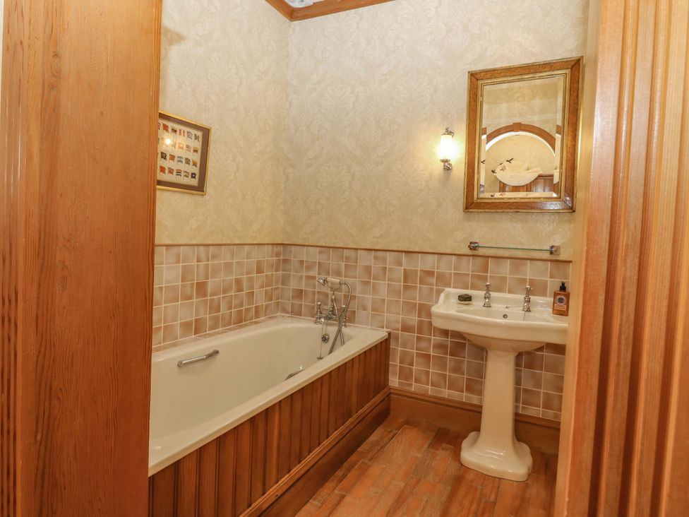 A bathroom with a bath tub and sink at Creag Bhalg Mar Lodge near Braemar