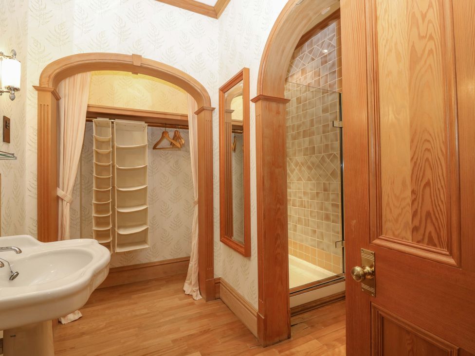 A bathroom with a sink and a shower at Creag Bhalg, Mar Lodge near Braemar