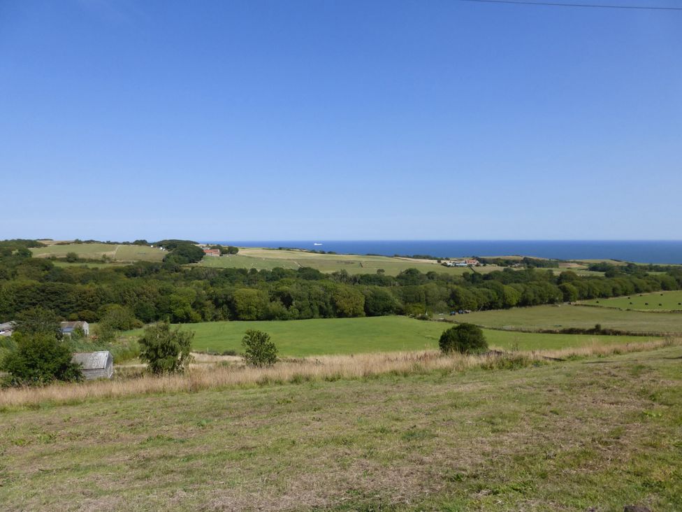 A landscape view of fields and ocean at Meadow Cottage in Staintondale near Cloughton