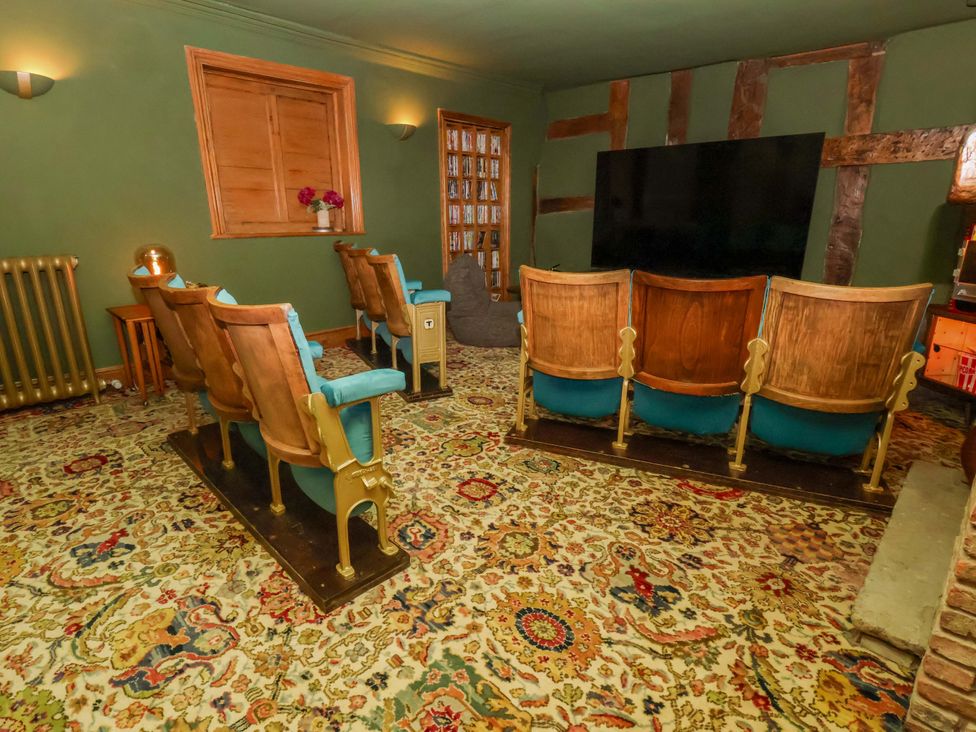 A snug with seating facing a television at Mickle Trafford Manor in Chester