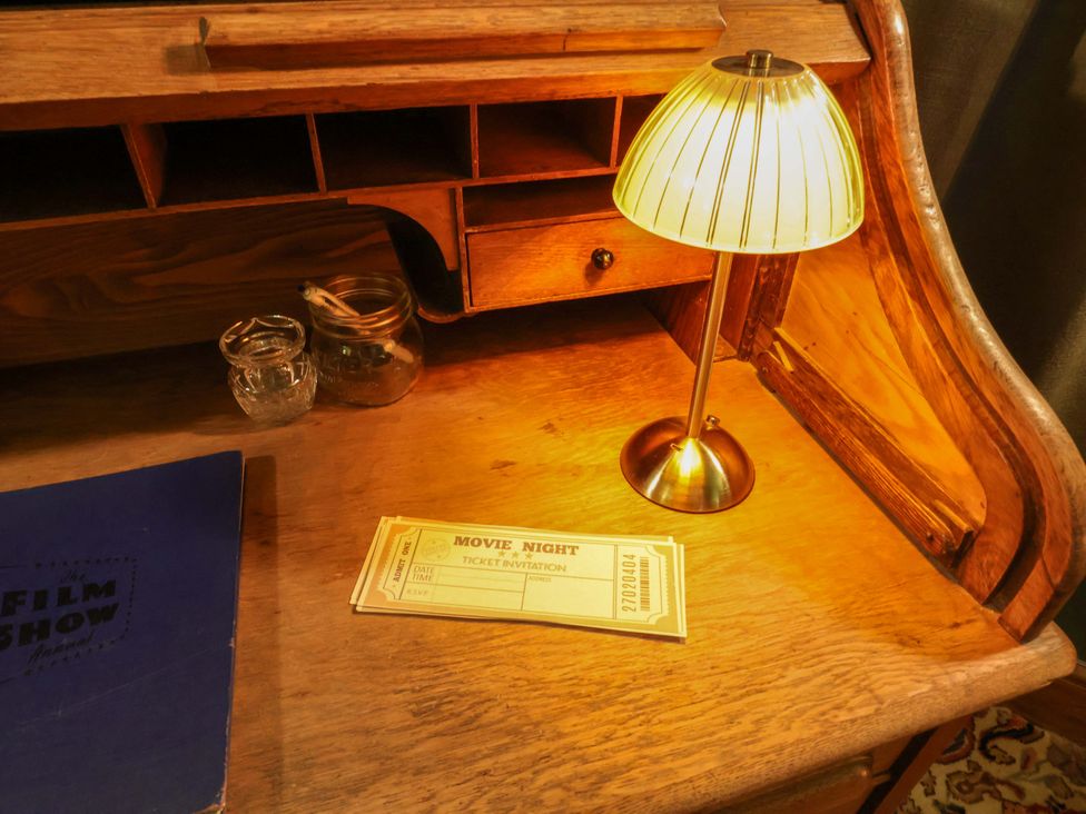 A desk with a lamp and movie night tickets at Mickle Trafford Manor, Chester