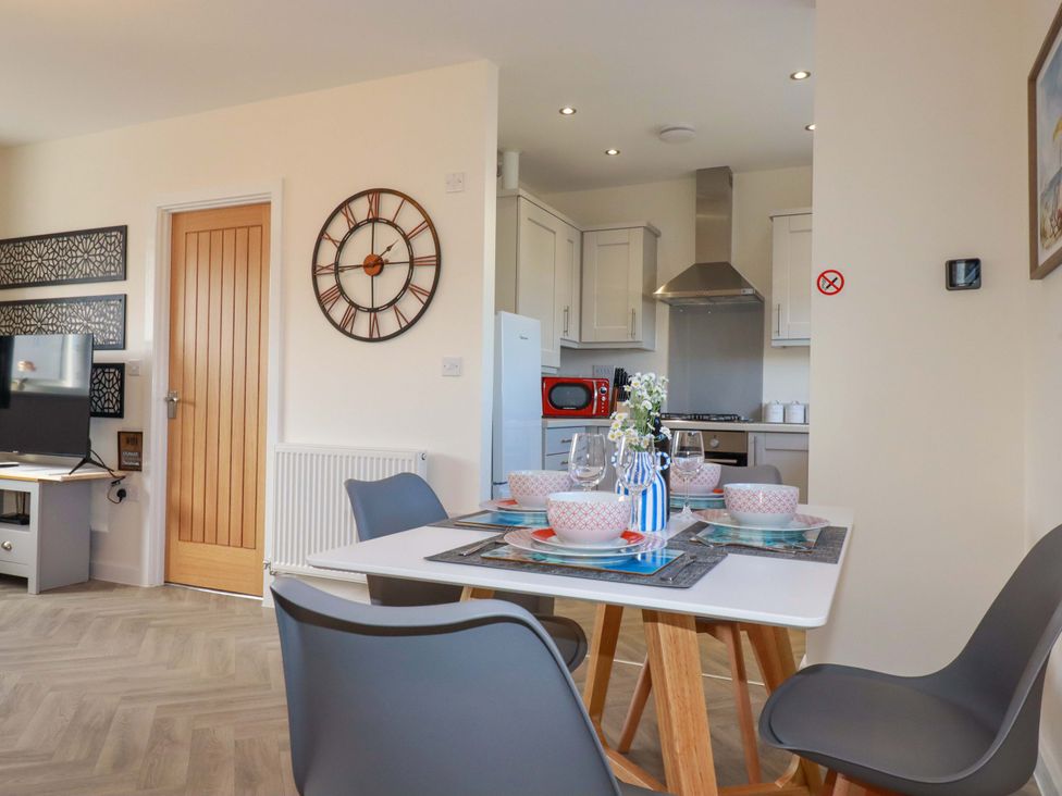 A dining room with a table set for dinner at 1 Vetch Avenue St Austell