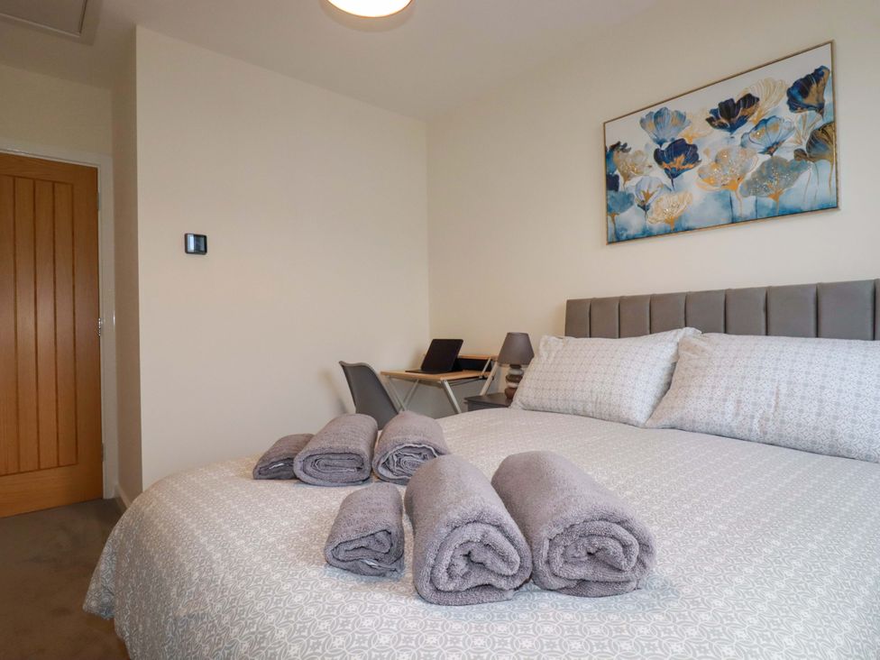 A bedroom with a bed and towels on it at 1 Vetch Avenue St Austell