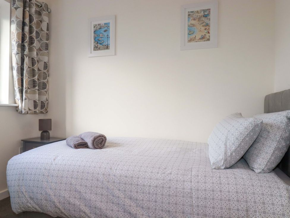 A bedroom with a bed and pillows at 1 Vetch Avenue St Austell