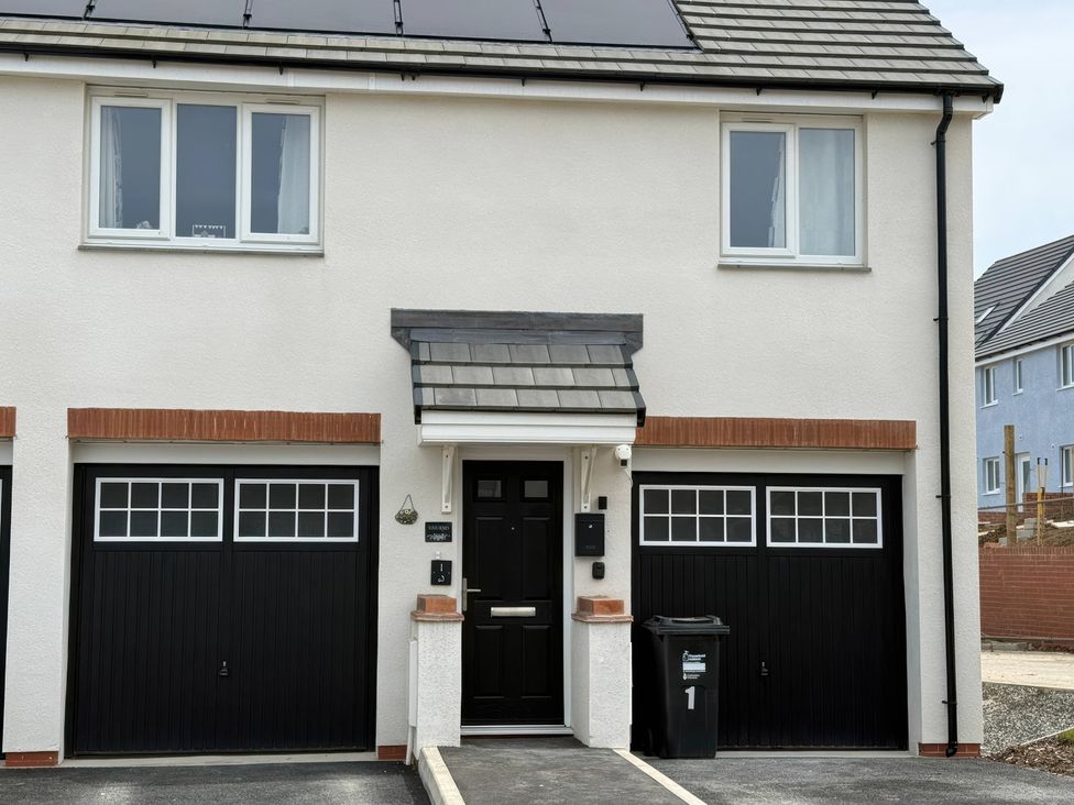 A house with a door and garage at Yonja Homes in St Austell