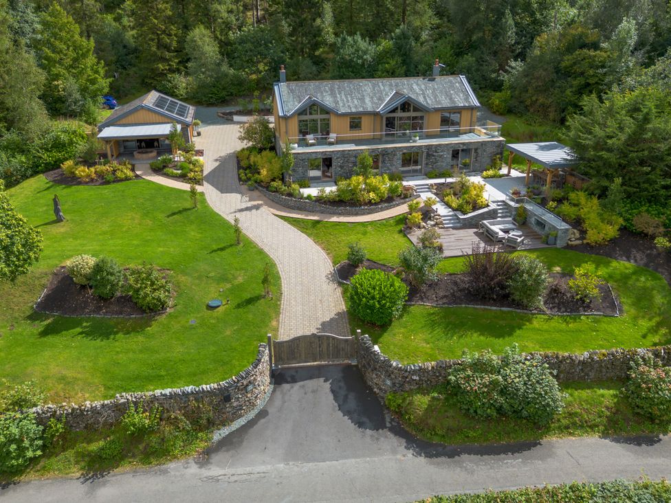 An outdoor view of a house with a garden and driveway at Deer Close, Coniston