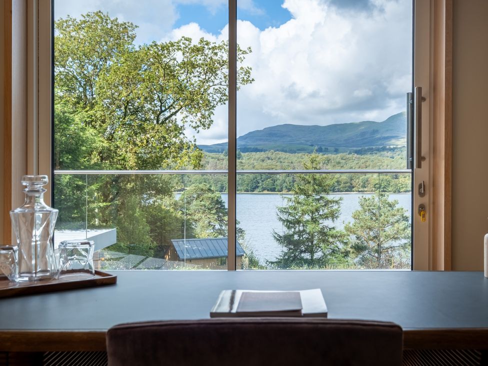 A window view of a lake and mountains at Deer Close in Coniston