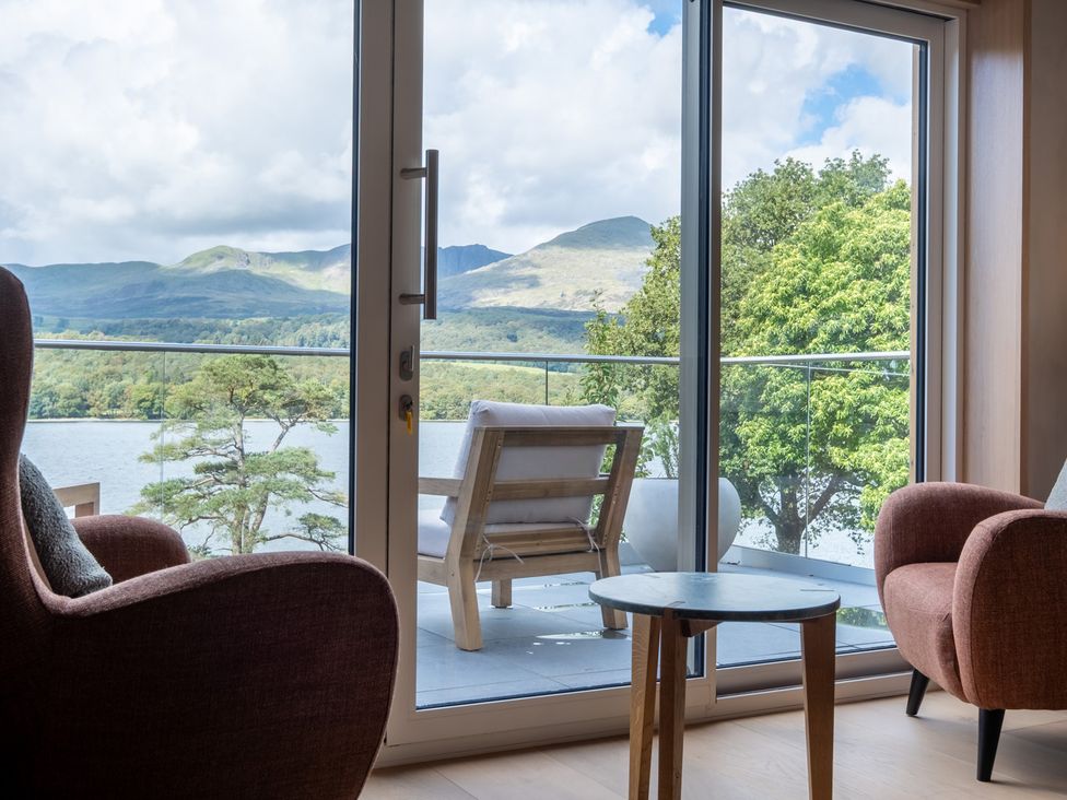 A living room with a view of mountains and water at Deer Close in Coniston