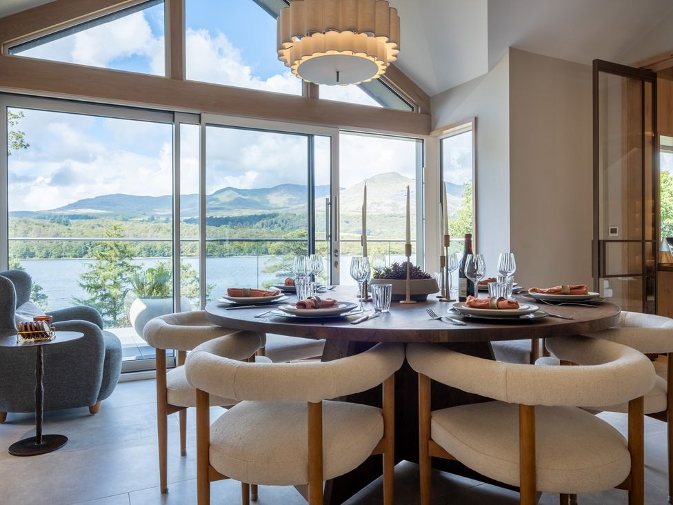 A dining room with a table set for meal at Deer Close in Coniston