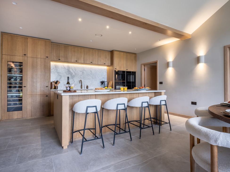 A kitchen with wooden cabinets and a central island at Deer Close in Coniston