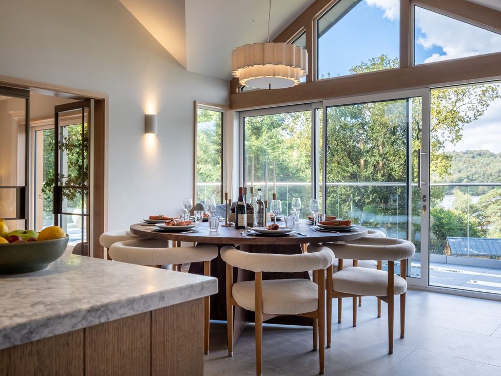 A dining room with a table set for meals at Deer Close in Coniston
