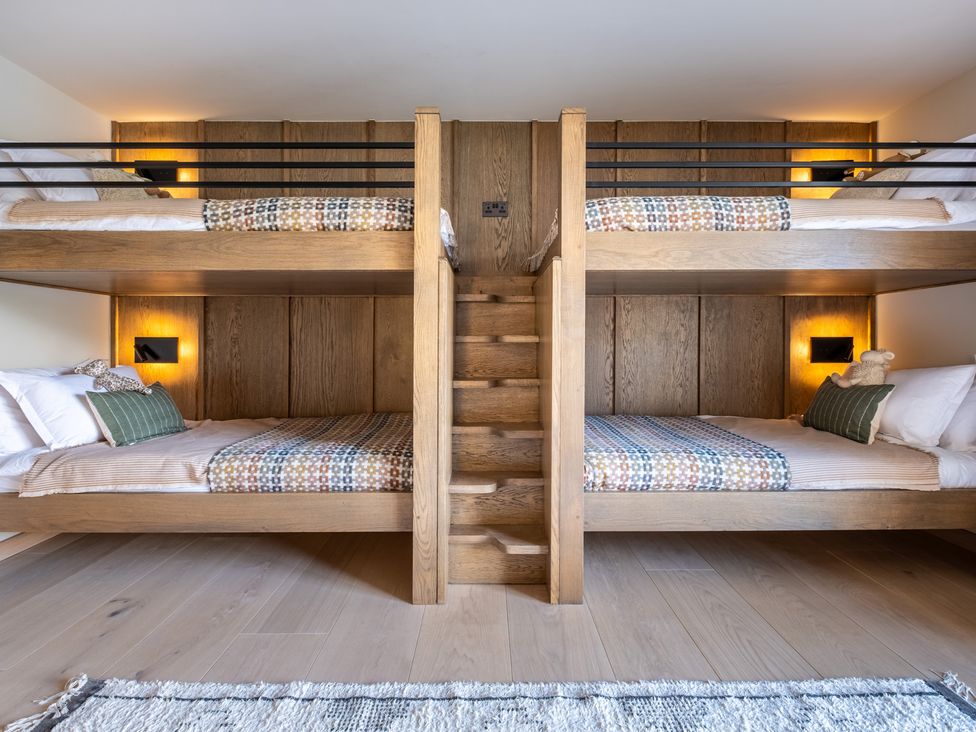 A bedroom with bunk beds and a staircase at Deer Close in Coniston