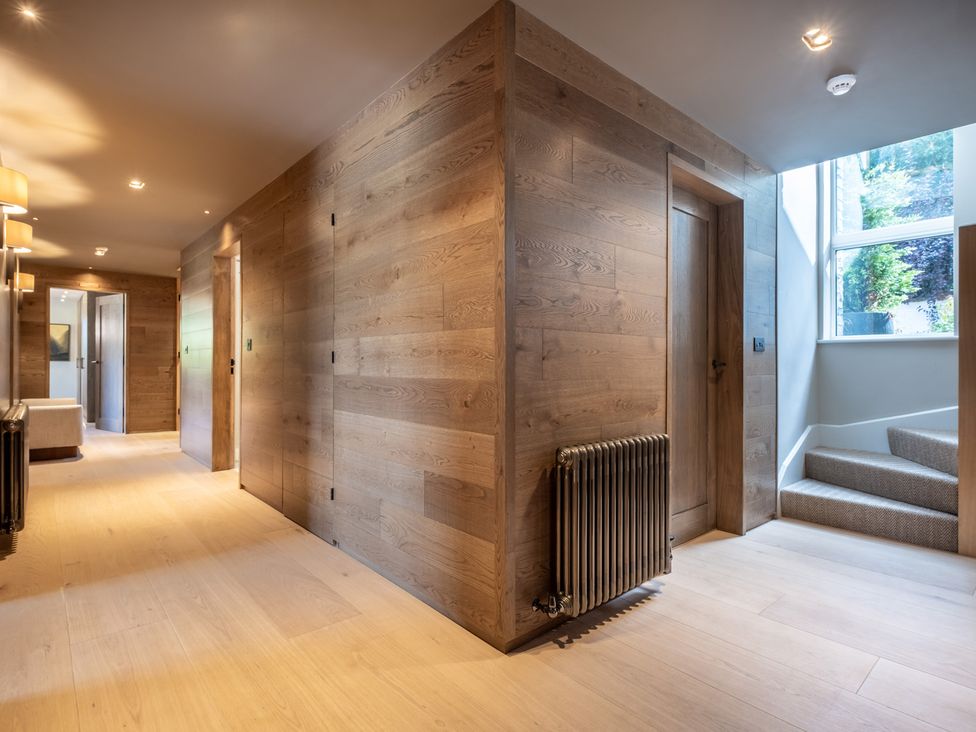 A hallway with wooden walls and a staircase at Deer Close in Coniston