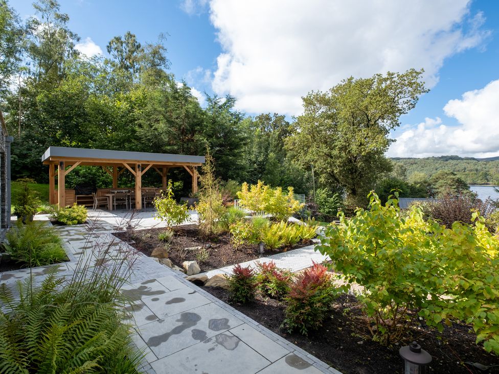 A garden with a gazebo and seating area at Deer Close in Coniston