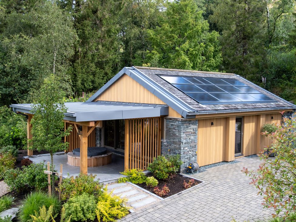 A house with solar panels and landscaped garden at Deer Close in Coniston