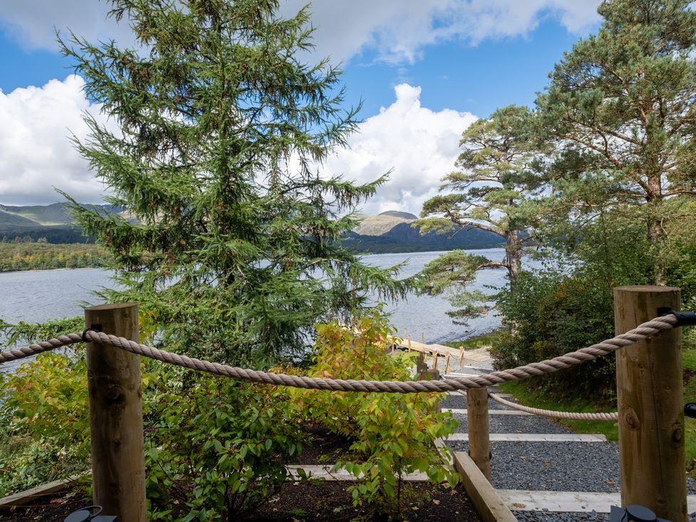 A view of trees and a lake at Deer Close in Coniston