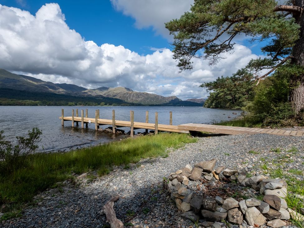 A wooden pier extending into a lake at Deer Close in Coniston