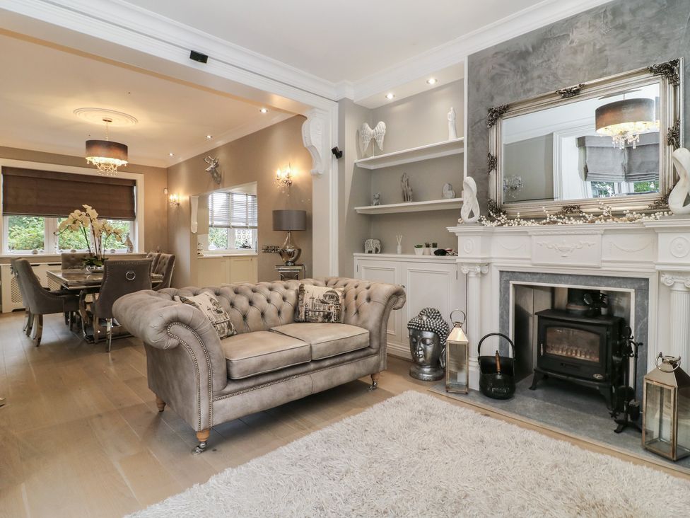 A living room with a sofa and fireplace at Ten Gables in Driffield