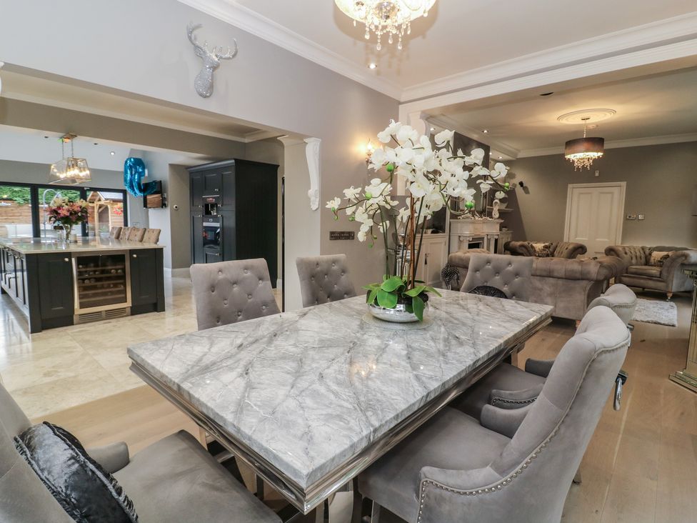 A dining room with a marble table and chairs at Ten Gables in Driffield