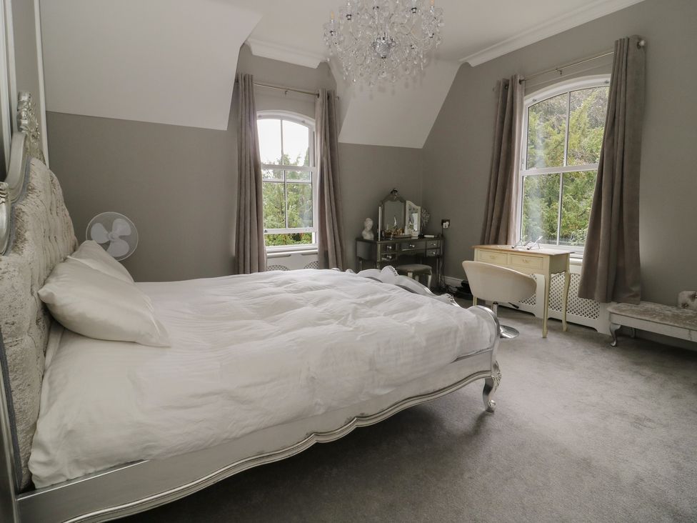 A bedroom with a bed and dresser at Ten Gables in Driffield